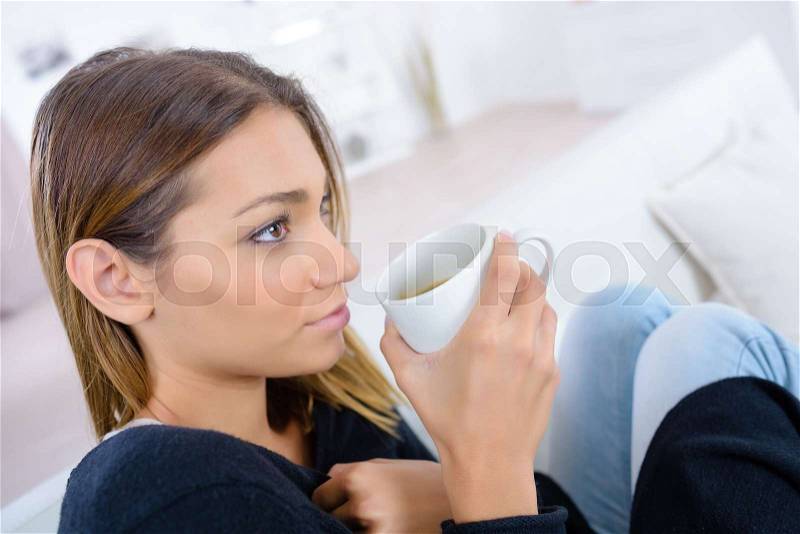 Beautiful woman enjoying the smell of coffee in the morning, stock photo