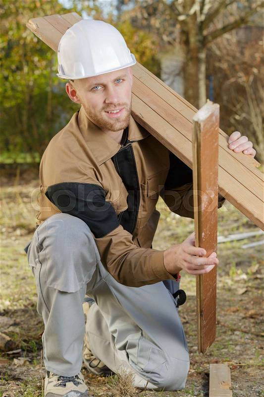 Builder gathering the remained wood, stock photo
