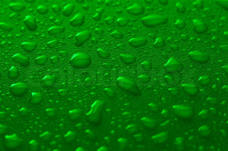 Green water drops background with yellow reflections, stock photo