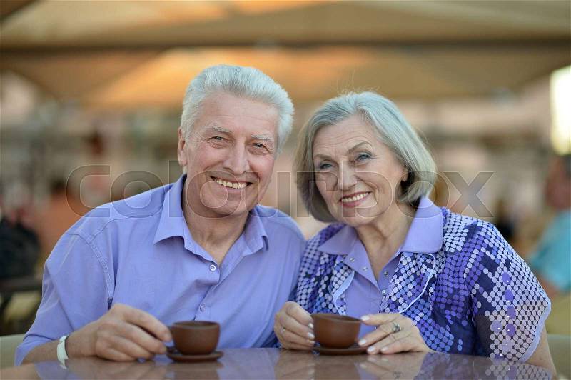 Senior couple drinking tea in outside in cafe, stock photo