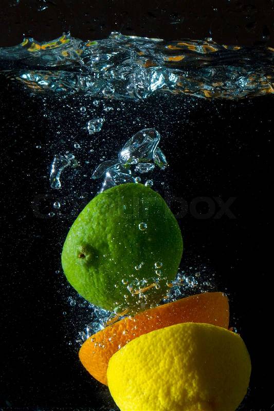 Fruit splashing in the water, stock photo
