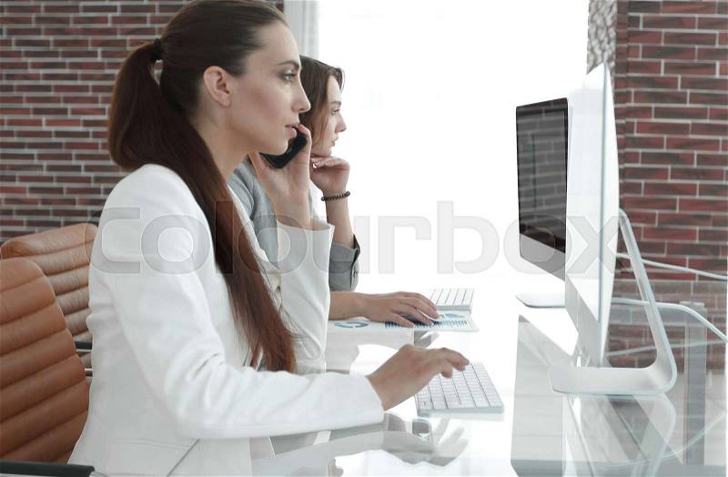 Employee of the company working at their workplace, stock photo