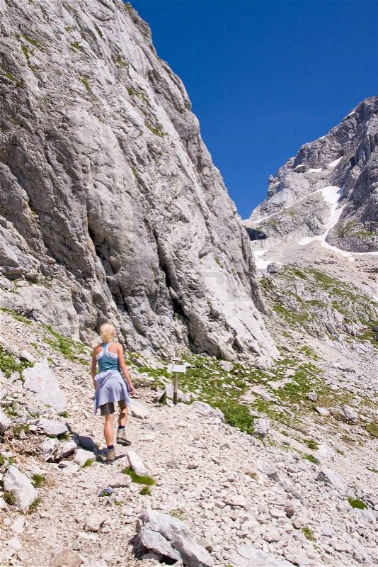 Female climbing ferrata in julian alps, slovenia, stock photo