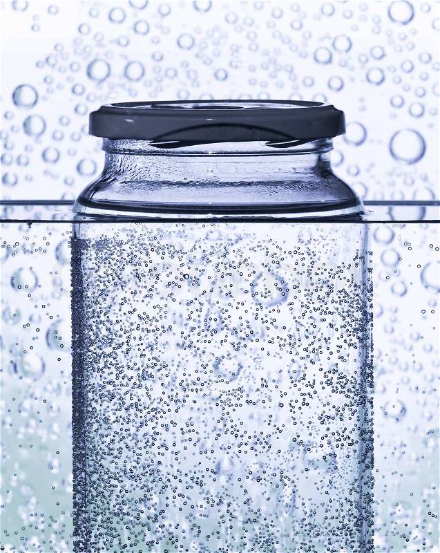 Glass bottle in a water tank as science abstract, stock photo
