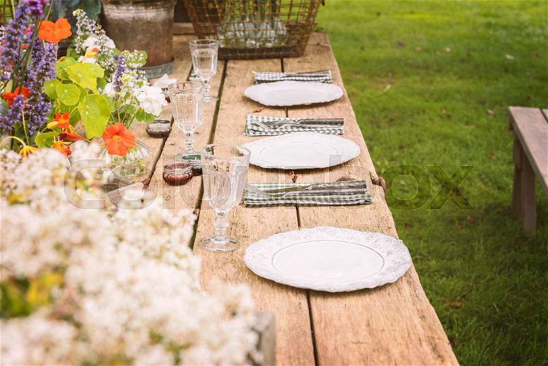 Wooden table setup for garden party or dinner reception. , stock photo