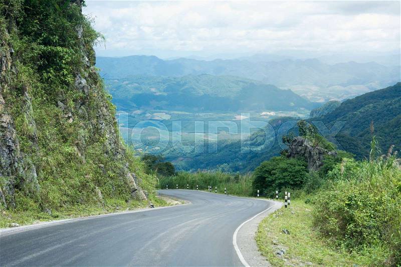 Long And Winding Rural Roads Leading Through Green Hills In Laos, The Route Between Vang Vieng - Luang Prabang, stock photo
