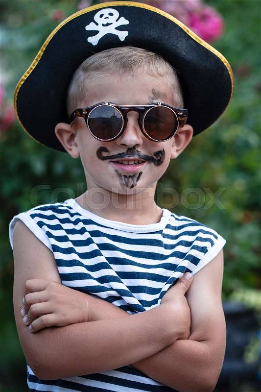 A cute little boy in a pirate costume, stock photo