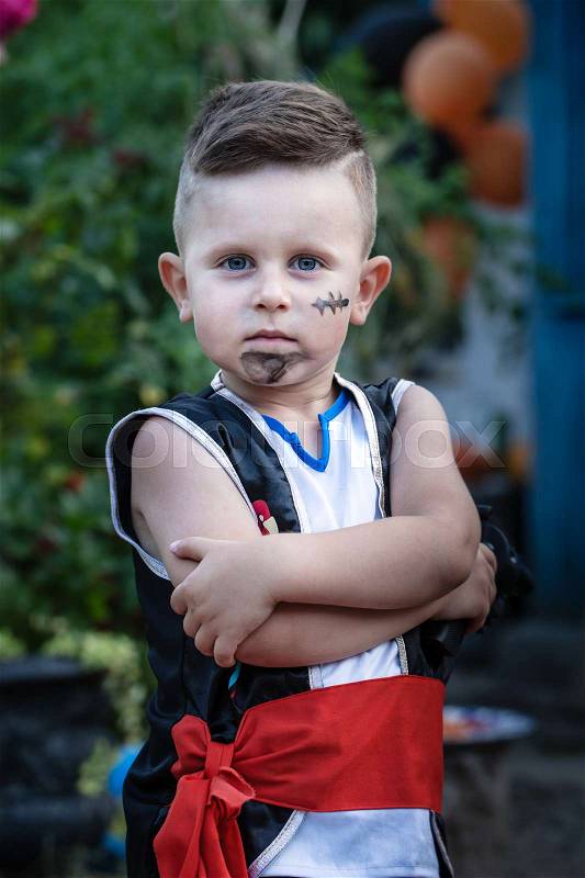 A cute little boy in a pirate costume, stock photo