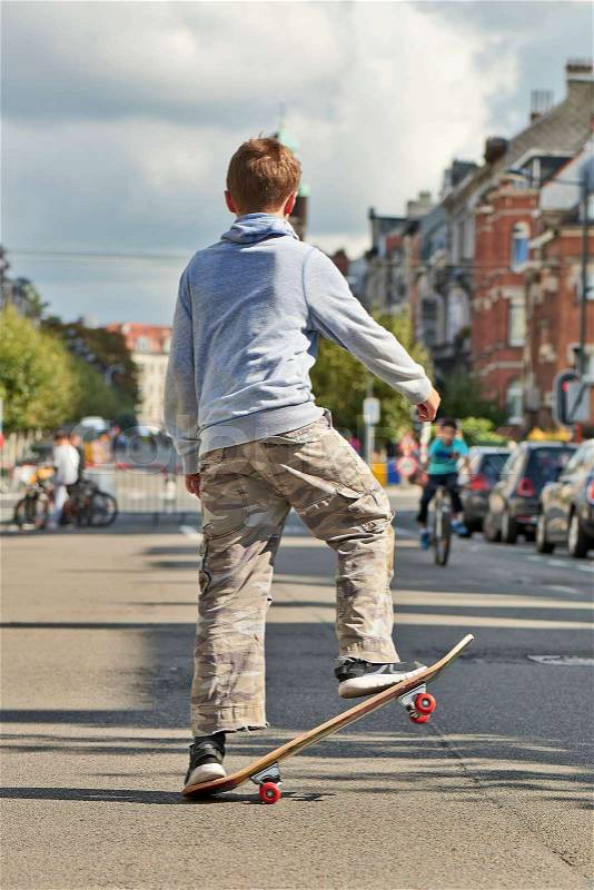 BRUSSELS, BELGIUM - SEPTEMBER 17, 2017: Young teenager boy practice skateboarding during the Car Free Streets day on Demolder Ave. in Brussels, Belgium, stock photo