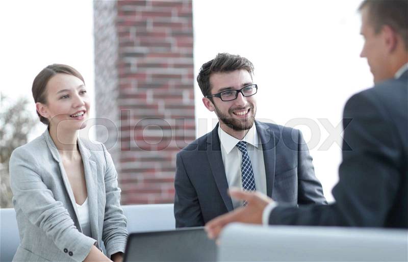 Members of the business team discuss with the client the terms of the contract, stock photo