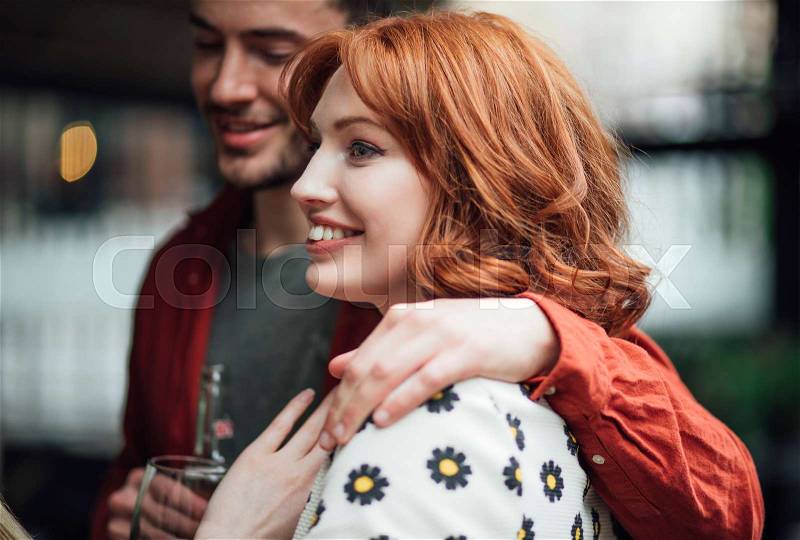 Close up shot of a millennial couple talking at a social event. , stock photo