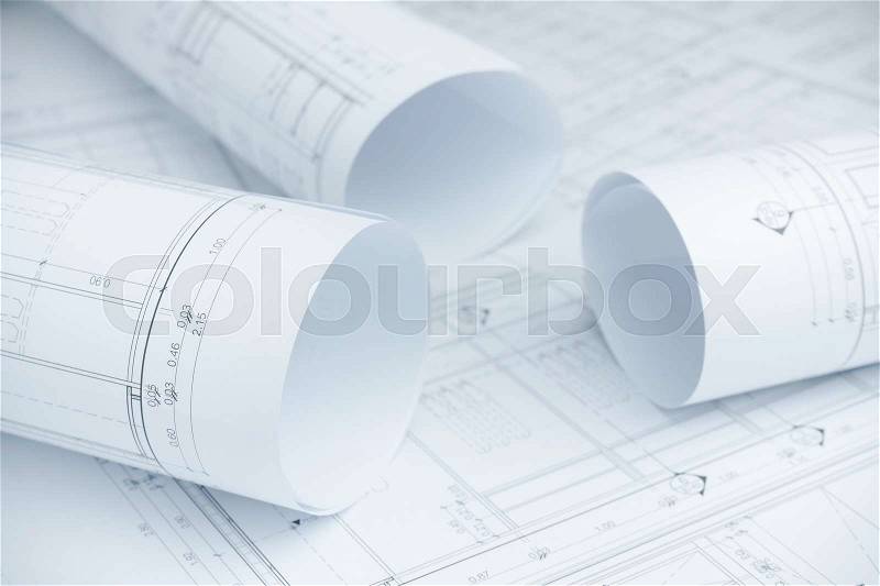 Architectural drawing paper rolls of a dwelling for construction, stock photo