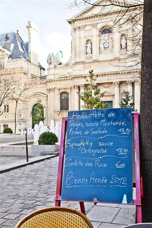 Black board with a menu restaurant in a tipical traditional square in Paris, stock photo