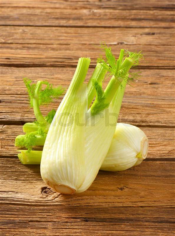 Bulbs of fresh fennel on wooden background, stock photo