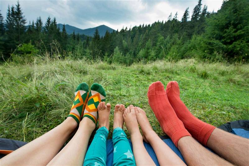 Legs of a family of four outdoors, stock photo