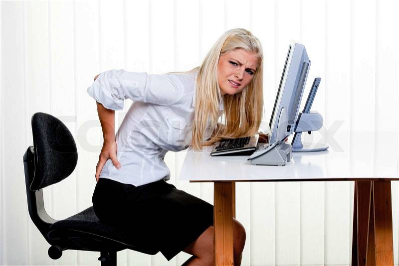 Young woman with pain in the back office, stock photo