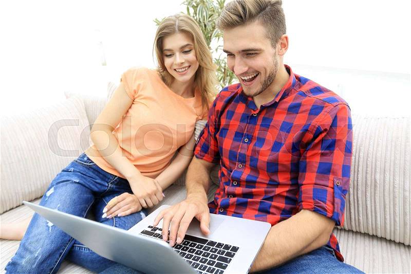 Happy modern couple surfing the net and working on laptop at home.photo with copy space, stock photo