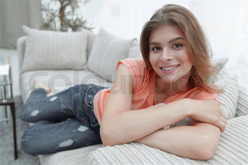 Young woman relaxing at home on the couch. the concept of comfort, stock photo