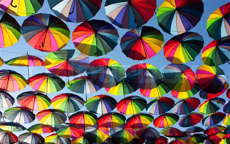Multi-colored umbrellas in the sky.Umbrellas rainbow colors, stock photo