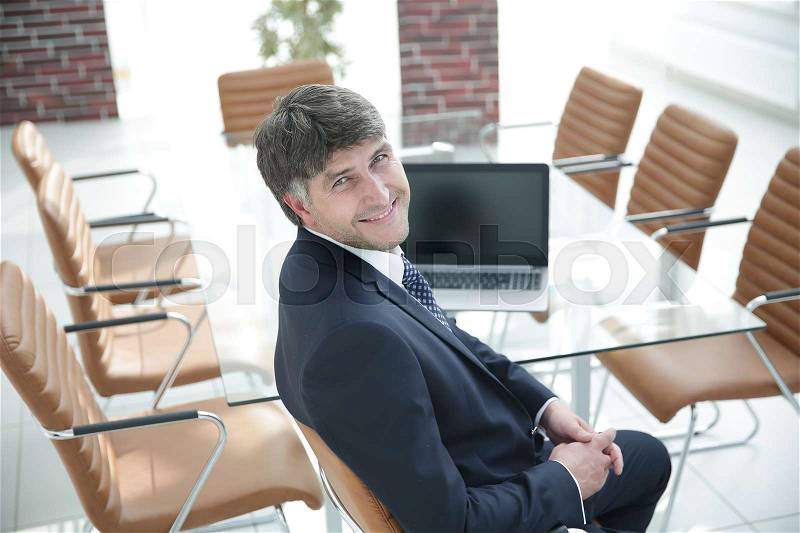 Manager sitting at work desk in meeting room. Business people, stock photo