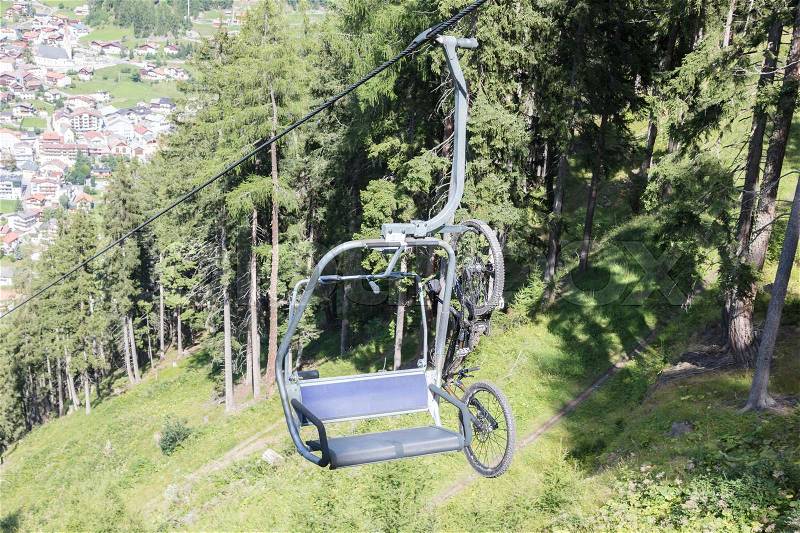 Ski lift chair in the Alps - Unrecognisable man in it - Austria, stock photo