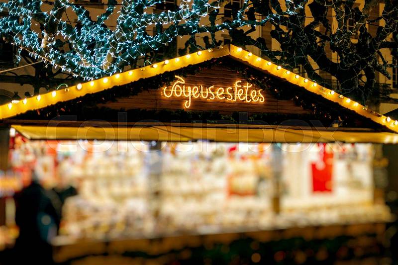 Illuminated Christmas fair kiosk market stall with loads traditional christmas kugelhopf sweets, biscuits, food , stock photo