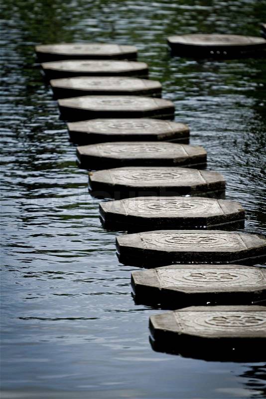 Stone steps floating on the water, Tirtagangga water palace, Bali, Indonesia, stock photo