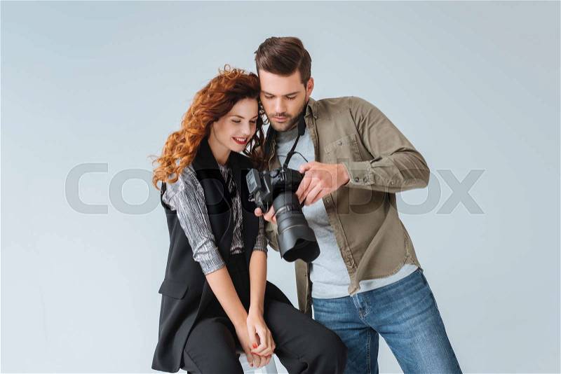Professional photographer and attractive model on fashion shoot in photo studio , stock photo