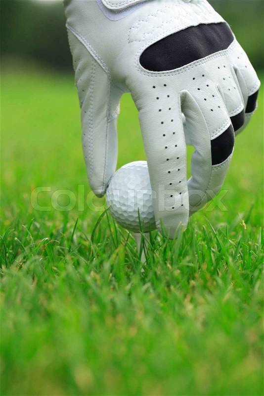 Detail of golf ball and gloves, stock photo