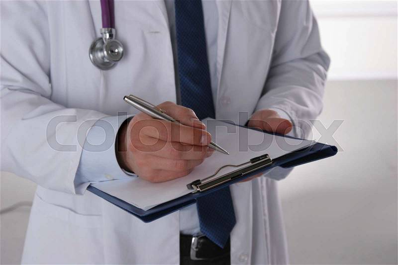 Male doctor standing with folder, isolated on white background, stock photo