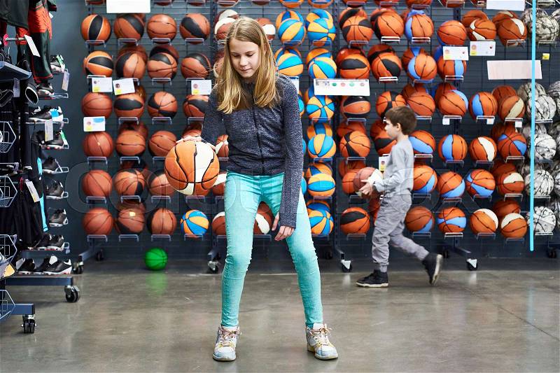 Children with basketballs in the sports shop, stock photo