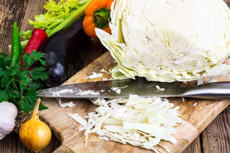 Cutting vegetables on wooden cutting board for cooking. Studio Photo, stock photo