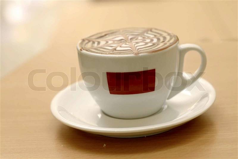A delicious capuccino in a cafe - space for your logo or name as original was removedFocus on foreground cup This image has a shallow dof, stock photo