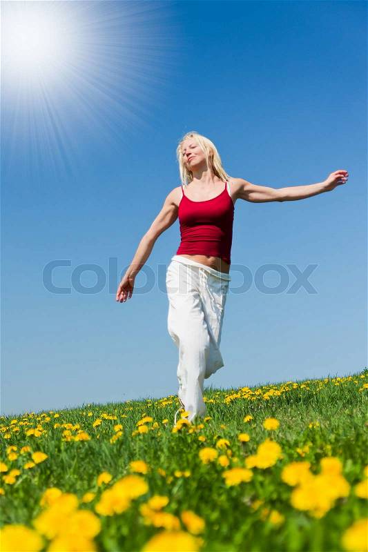 Young woman having fun on a flowery meadow, stock photo