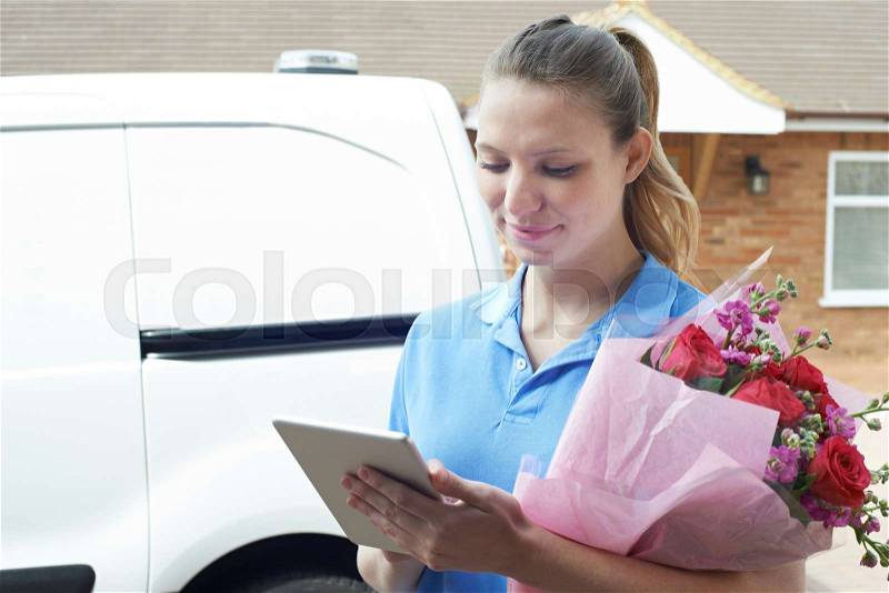 Florist With Digital Tablet Making Home Delivery Of Bouquet , stock photo