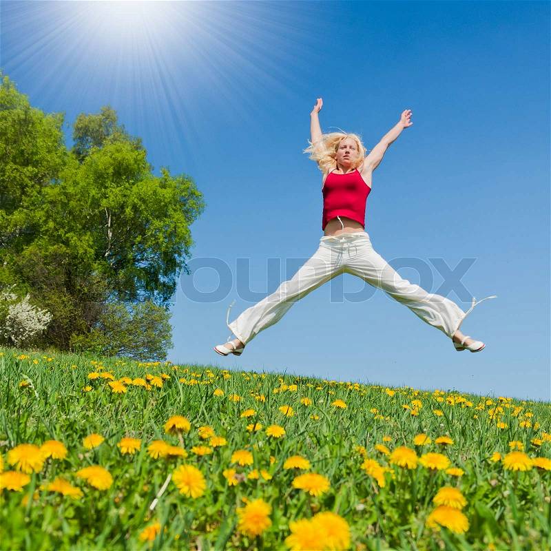 Young woman having fun on a flowery meadow, stock photo