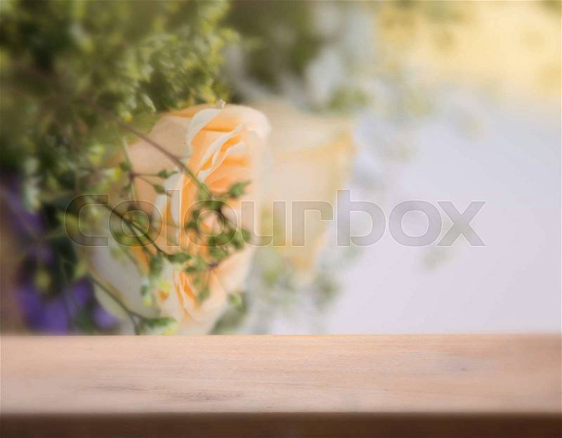 Beautiful rose flower with wood top and soft blurred background, stock photo