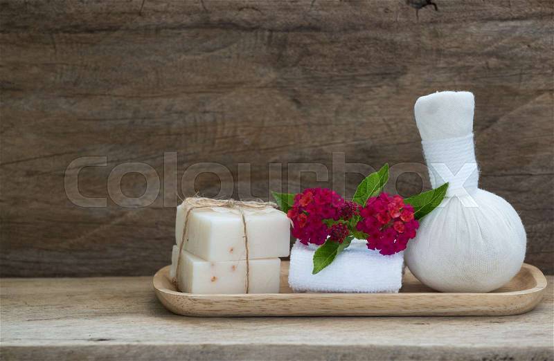 Spa soap and herbal massage ball aromatherapy products on wooden background, stock photo