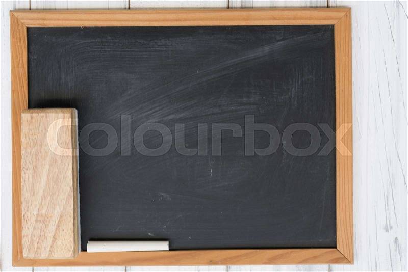 Blank black board,white chalk and eraser on grunge wooden background, stock photo