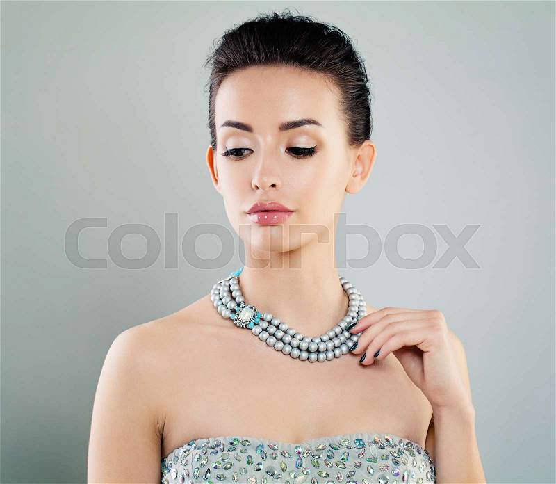 Nice Young Woman with Makeup, Manicure and Jewelry Necklace, stock photo