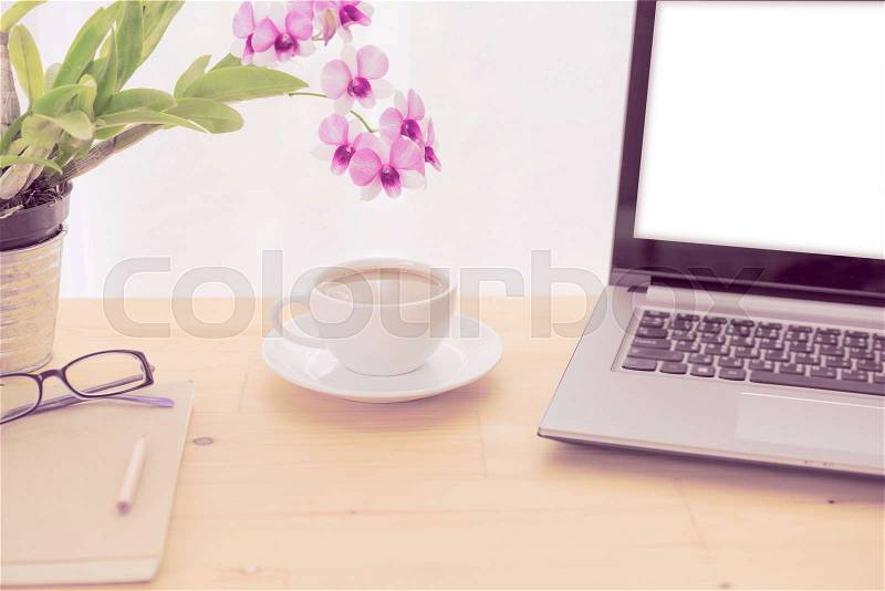 Minimal workspace,computer laptop,coffee cup,orchid flower and notebook on wooden table over white background ,retro filter, stock photo