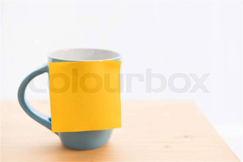 Blue coffee cup and post it for text on wood table top, stock photo