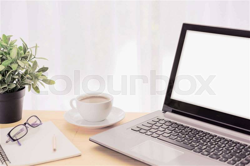 Minimal workspace,computer laptop,coffee cup,green flowerpot,eyeglasses and notebook on wooden table over curtain white background, stock photo