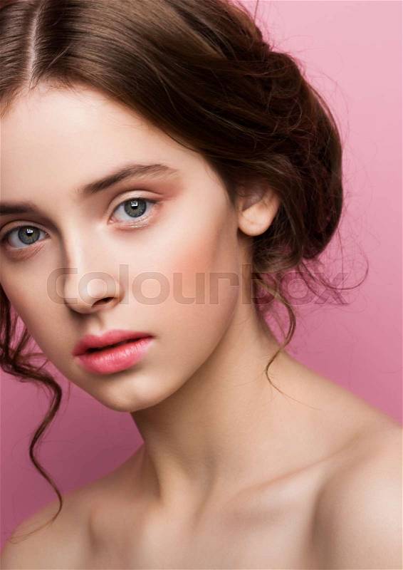 Beauty cute fashion model with natural make up on pink background, stock photo
