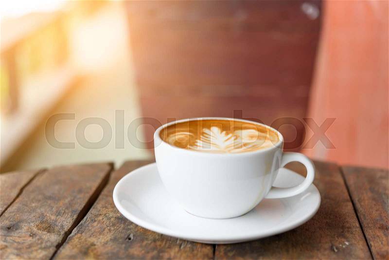 Coffee cup Latte art on old vintage blue wood table outdoor with copy space for text, stock photo