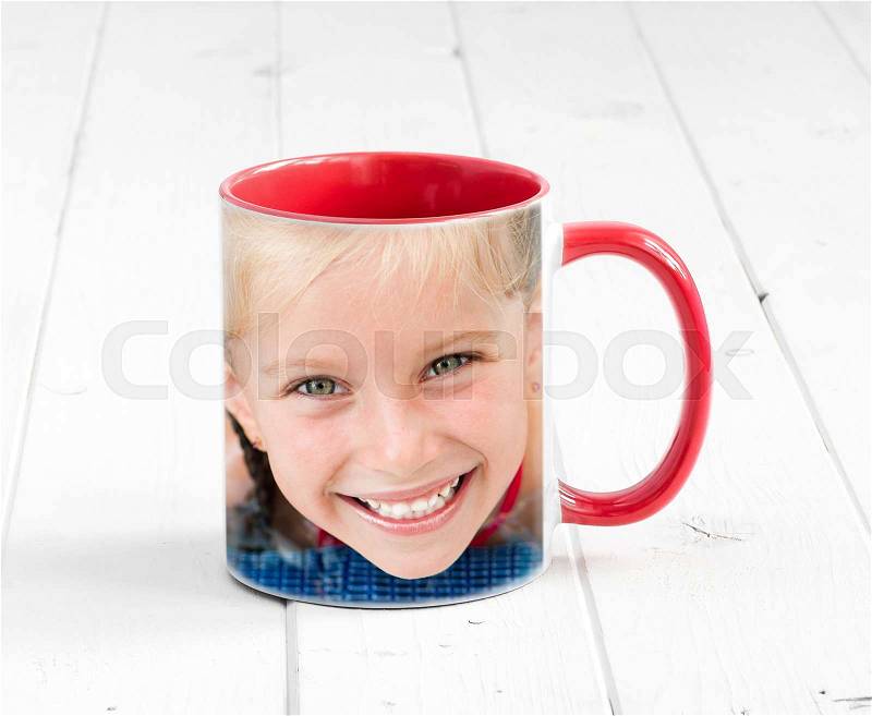 Simple cup red on the inside with a print, smiling blonde girl, stock photo