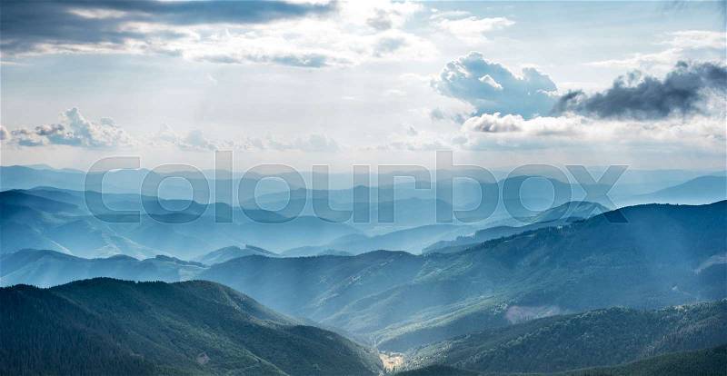 Mountain landscape with sun beams in ukrainian Carpathiaan, stock photo