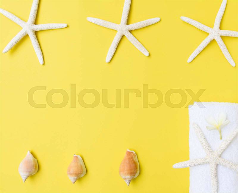Flat lay star fish,flower and white towel on yellow background,summer collection, stock photo
