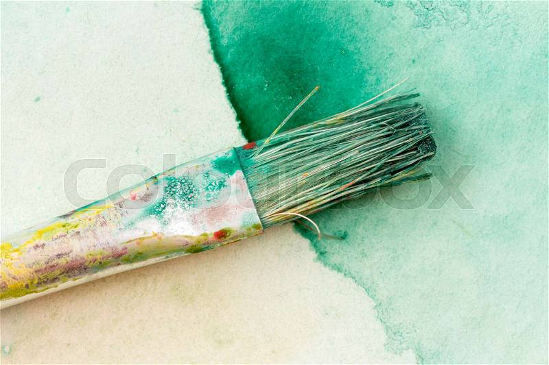 Watercolor brushe on green painting, close-up , stock photo