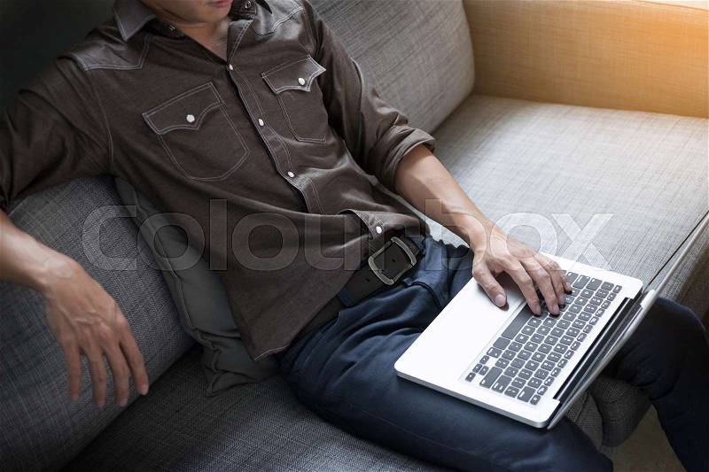 Businessman works on the sofa at home. Work searching for new idea creative and drinking hot coffee feeling think hard, stock photo